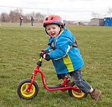 A young festival goer takes to two wheels